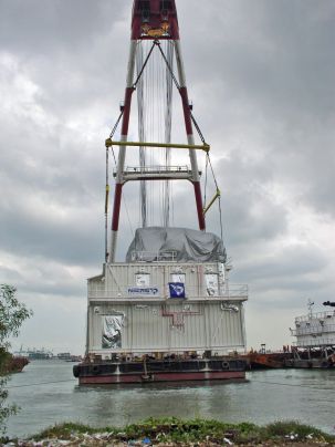 An offshore Electrical/Control Building loaded onto a barge for transportation